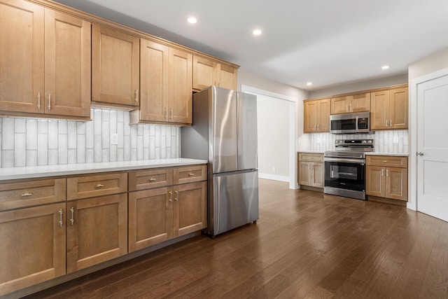 2012 Spruce Ln, Monticello, IL 61856 - kitchen with appliances with stainless steel finishes, tasteful backsplash, recessed lighting, light countertops, and dark wood-style floors
