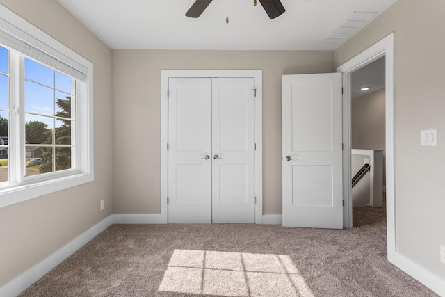 2012 Spruce Ln, Monticello, IL 61856 - unfurnished bedroom with carpet, a closet, baseboards, and ceiling fan