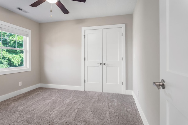 2012 Spruce Ln, Monticello, IL 61856 - unfurnished bedroom with carpet flooring, a closet, baseboards, and a ceiling fan
