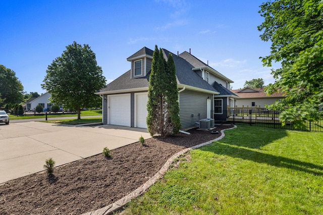 2012 Spruce Ln, Monticello, IL 61856 - view of side of home featuring a garage, cooling unit, and a shingled roof