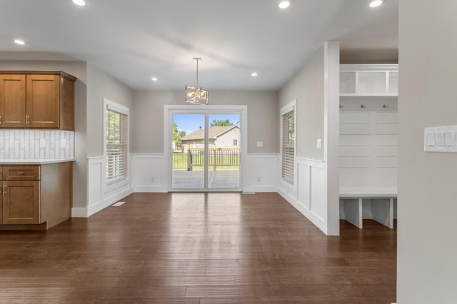 2012 Spruce Ln, Monticello, IL 61856 - unfurnished dining area featuring dark wood-type flooring, a wainscoted wall, recessed lighting, a decorative wall, and a chandelier