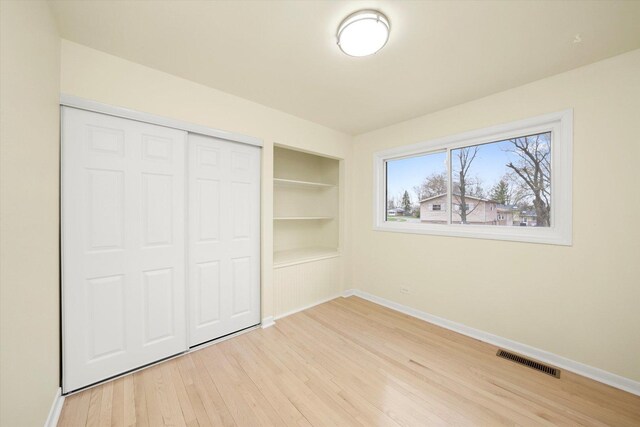 236 Early St, Park Forest, IL 60466 - unfurnished bedroom featuring baseboards, light wood finished floors, and a closet