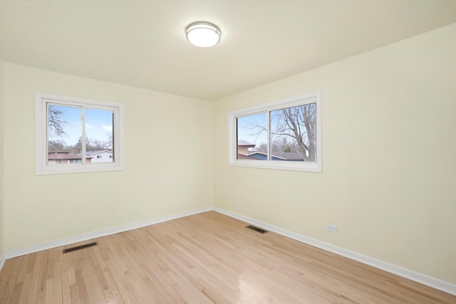 236 Early St, Park Forest, IL 60466 - empty room featuring healthy amount of natural light, light wood-style floors, and baseboards