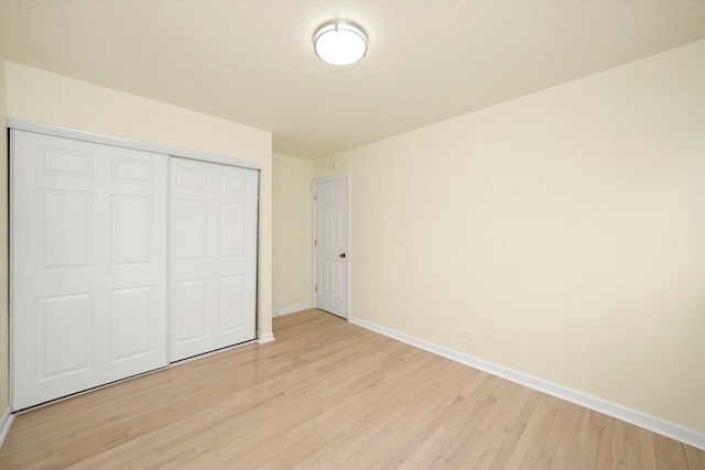 236 Early St, Park Forest, IL 60466 - unfurnished bedroom with baseboards, light wood-style flooring, and a closet