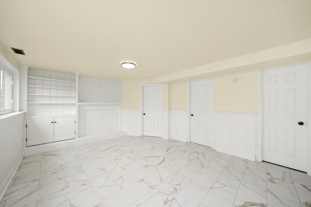 236 Early St, Park Forest, IL 60466 - spare room with a wainscoted wall, light marble finish flooring, and a decorative wall