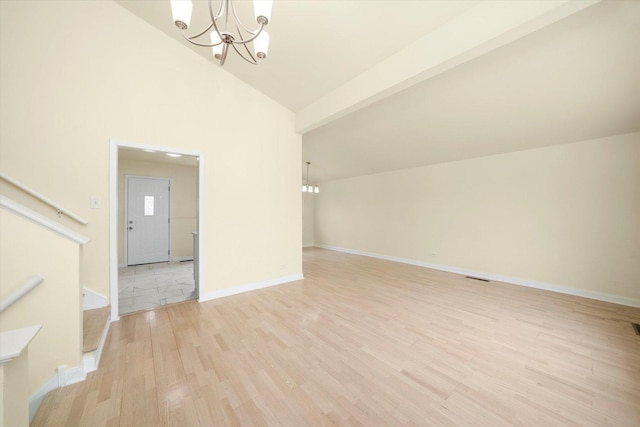 236 Early St, Park Forest, IL 60466 - unfurnished living room featuring a chandelier, light wood-style floors, stairs, vaulted ceiling, and baseboards