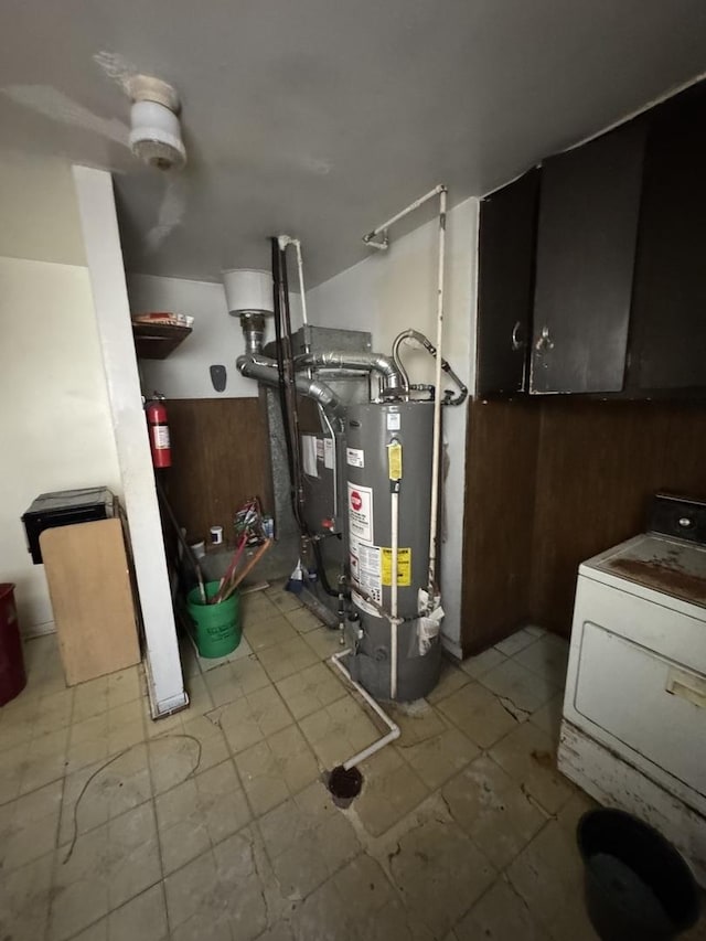 utilities with gas water heater, washer / dryer, and heating unit
