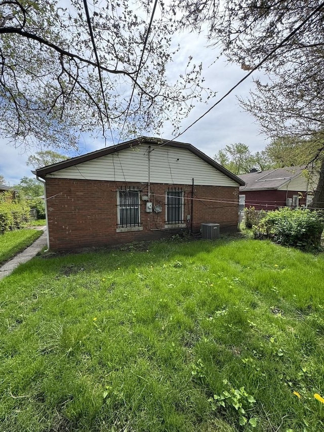 rear view of house with brick siding and central air condition unit