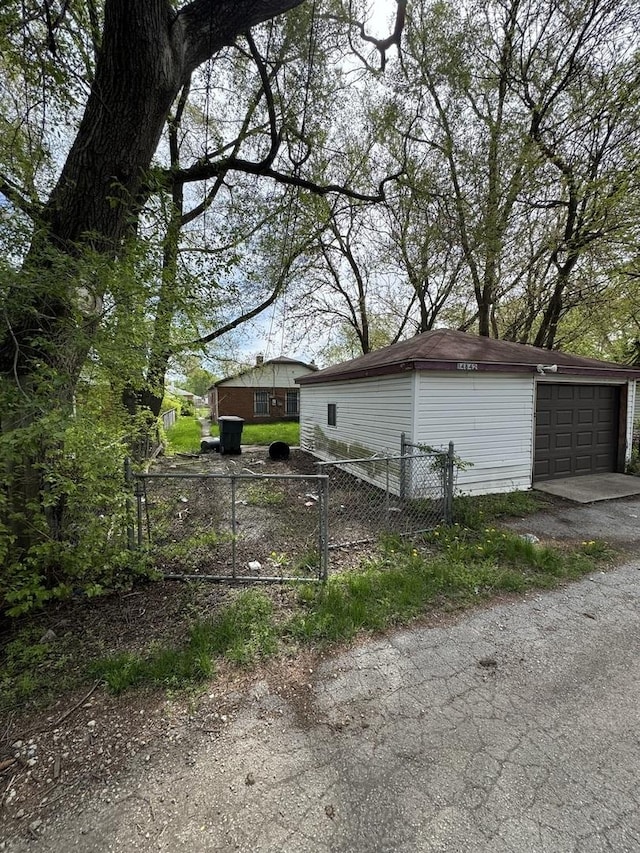 detached garage featuring fence
