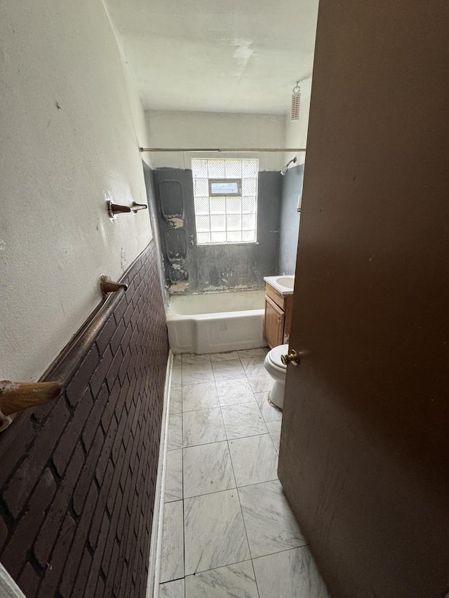 bathroom featuring marble finish flooring, toilet, shower / bath combination, and vanity