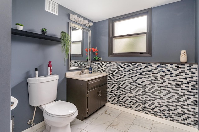 1339 Addleman St, Joliet, IL 60431 - bathroom with marble look tiles, toilet, and vanity