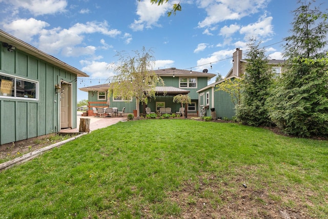 1339 Addleman St, Joliet, IL 60431 - back of property featuring board and batten siding, a patio, a lawn, and a gazebo