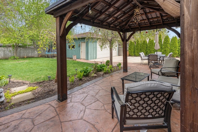 1339 Addleman St, Joliet, IL 60431 - view of patio / terrace with a trampoline, an outbuilding, outdoor dining area, and a gazebo