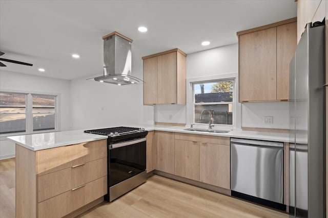 1416 3rd St, Winthrop Harbor, IL 60096 - kitchen featuring light brown cabinets, stainless steel appliances, wall chimney exhaust hood, a peninsula, and a sink