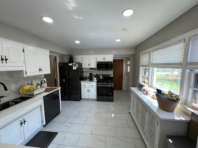 7700 Le Claire Ave, Skokie, IL 60077 - kitchen featuring black appliances, light marble finish flooring, a sink, light countertops, and recessed lighting