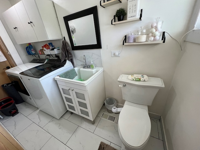 7700 Le Claire Ave, Skokie, IL 60077 - bathroom with washer / clothes dryer, marble finish flooring, and toilet