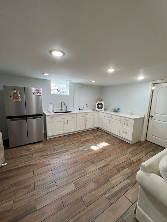 7700 Le Claire Ave, Skokie, IL 60077 - kitchen with freestanding refrigerator, a sink, wood finished floors, white cabinetry, and light countertops