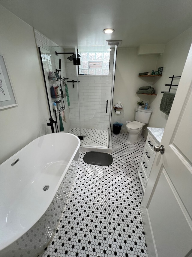 7700 Le Claire Ave, Skokie, IL 60077 - full bath featuring a stall shower, a freestanding tub, toilet, vanity, and tile patterned floors