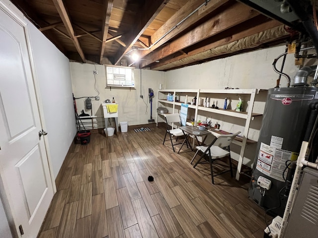 7700 Le Claire Ave, Skokie, IL 60077 - below grade area featuring gas water heater, wood finished floors, a sink, and baseboards