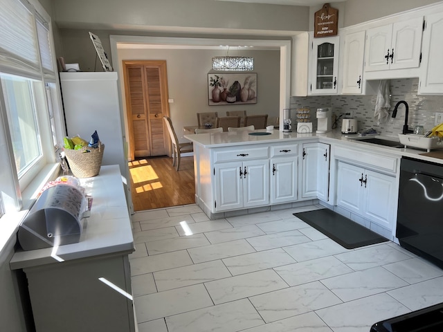 7700 Le Claire Ave, Skokie, IL 60077 - kitchen with a sink, dishwashing machine, light countertops, light marble finish floors, and white cabinetry