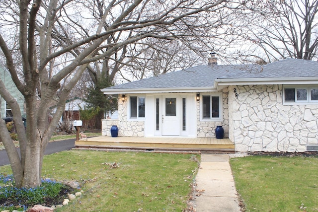 29 S Ash St, Palatine, IL 60067 - view of front of house featuring stone siding, a chimney, a front lawn, and a deck