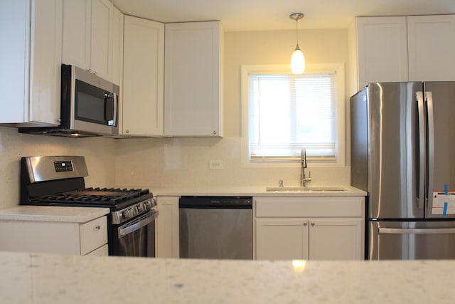 29 S Ash St, Palatine, IL 60067 - kitchen featuring stainless steel appliances, a sink, white cabinetry, and decorative light fixtures