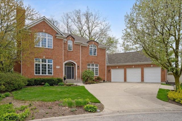 view of front facade with an attached garage, concrete driveway, brick siding, and a front lawn