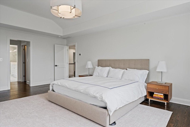 bedroom with dark wood finished floors, baseboards, and lofted ceiling