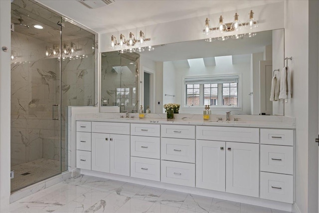 full bath with marble look tiles, a marble finish shower, and double vanity