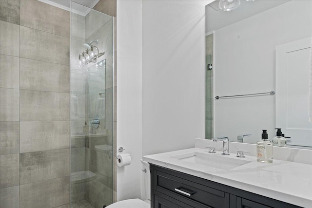 full bathroom featuring a shower stall, toilet, and vanity
