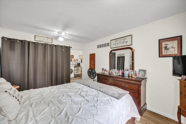 1216 N Oak St, Bloomington, IL 61701 - bedroom with washer / clothes dryer, wood finished floors, and a ceiling fan