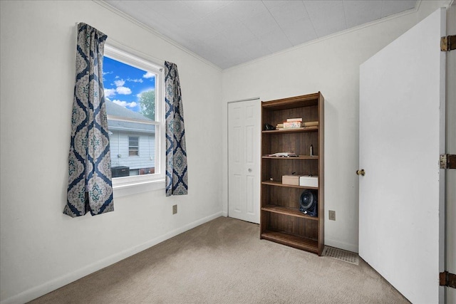 1216 N Oak St, Bloomington, IL 61701 - unfurnished bedroom with carpet and crown molding
