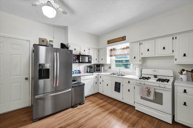 1216 N Oak St, Bloomington, IL 61701 - kitchen featuring white appliances, white cabinetry, a textured ceiling, light countertops, and ceiling fan