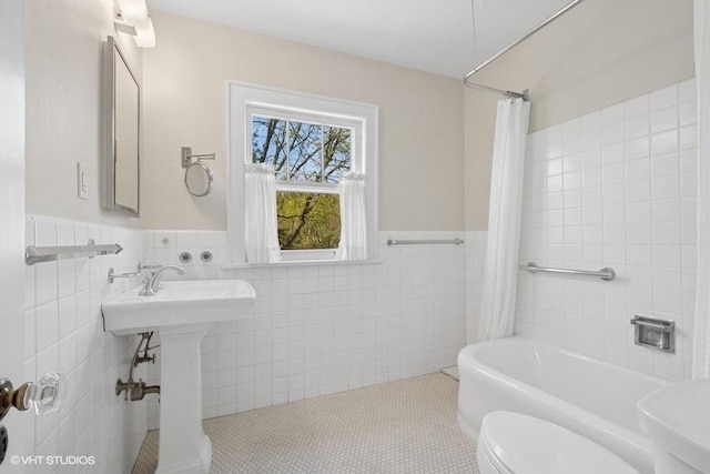 2206 Forestview Rd, Evanston, IL 60201 - bathroom with tile walls, toilet, wainscoting, shower / bathtub combination with curtain, and tile patterned floors
