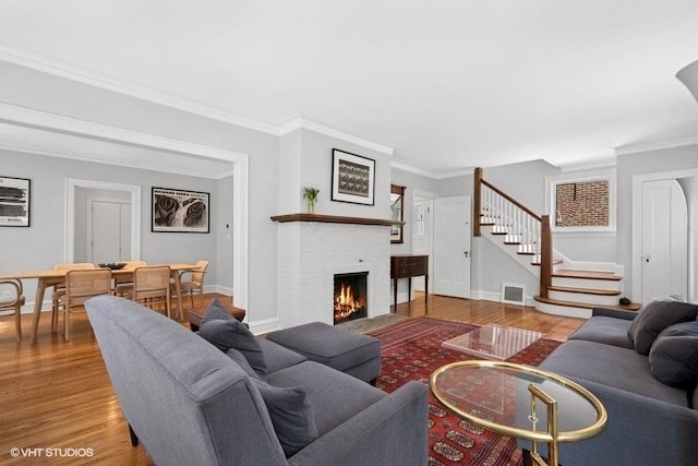 2206 Forestview Rd, Evanston, IL 60201 - living area featuring stairway, wood finished floors, baseboards, a fireplace, and ornamental molding