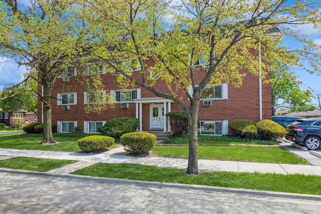 view of front of home featuring a front yard and brick siding