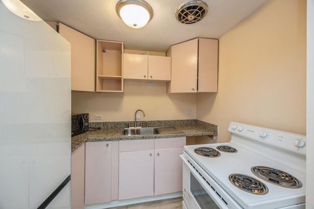 kitchen featuring white range with electric cooktop and a sink