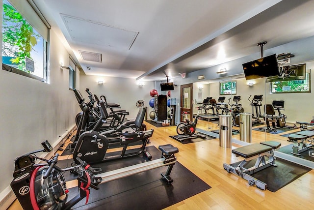 exercise room with wood finished floors
