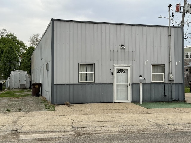 view of front of home with an outbuilding, a storage unit, and board and batten siding