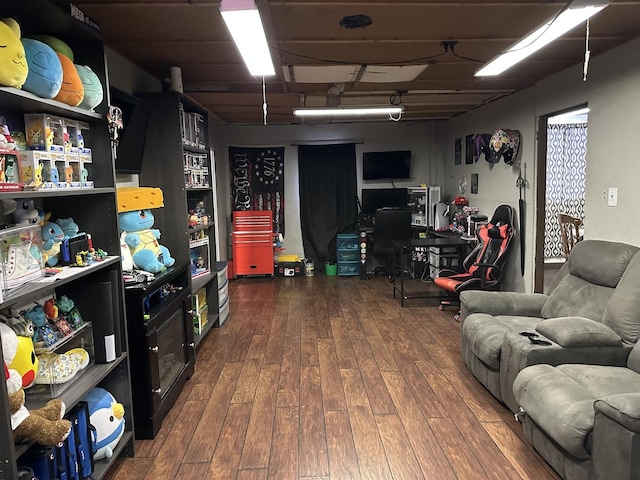 basement with hardwood / wood-style floors and a desk