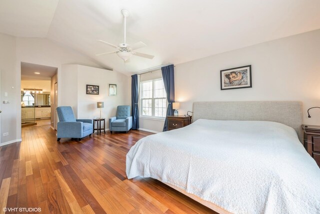 7181 Dada Dr, Gurnee, IL 60031 - bedroom featuring wood finished floors, lofted ceiling, baseboards, a ceiling fan, and ensuite bath