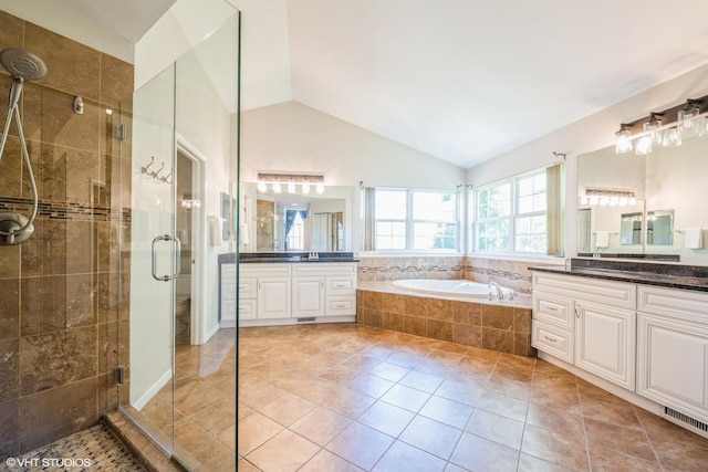 7181 Dada Dr, Gurnee, IL 60031 - full bathroom featuring a shower stall, a bath, vaulted ceiling, tile patterned floors, and two vanities