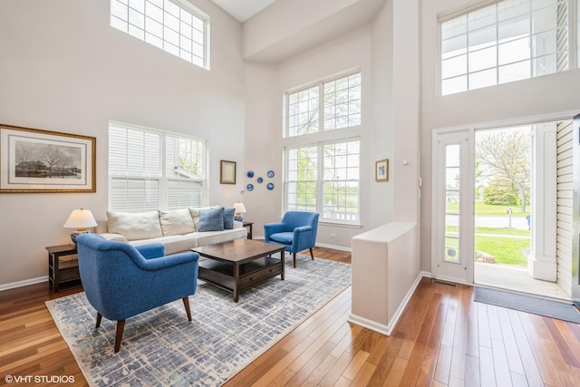 7181 Dada Dr, Gurnee, IL 60031 - living room featuring a high ceiling, wood-type flooring, and baseboards