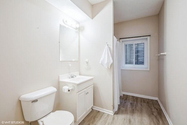 7181 Dada Dr, Gurnee, IL 60031 - bathroom featuring wood finished floors, toilet, vanity, and baseboards