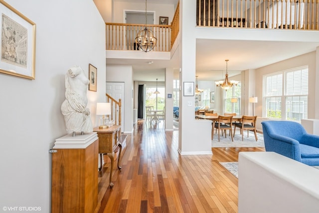 7181 Dada Dr, Gurnee, IL 60031 - entryway featuring a chandelier, plenty of natural light, light wood-style floors, baseboards, and a towering ceiling