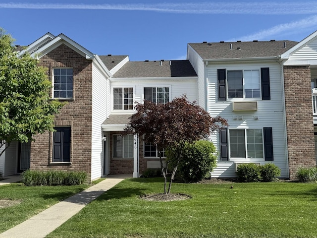 1646 Mcclure Rd Unit 1646, Aurora, IL 60505 - townhome / multi-family property with brick siding, a front yard, and roof with shingles
