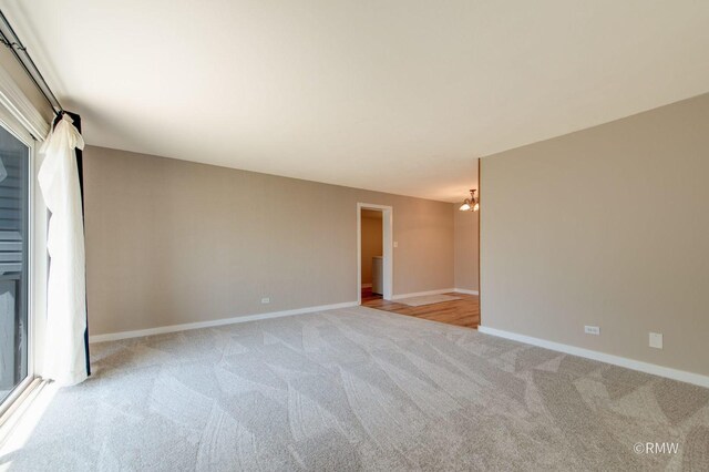 231 Barcliffe Ln Unit 231, Schaumburg, IL 60194 - unfurnished room with light colored carpet, baseboards, and a chandelier