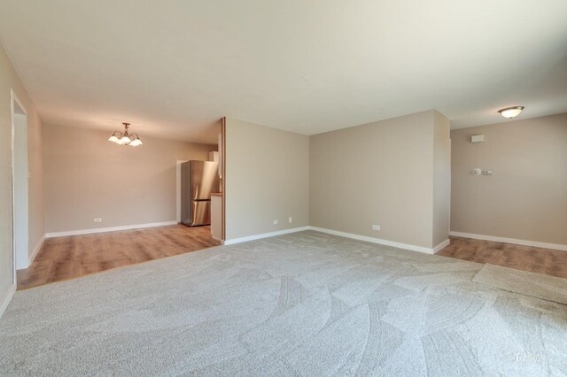 231 Barcliffe Ln Unit 231, Schaumburg, IL 60194 - empty room with light carpet, a chandelier, and baseboards