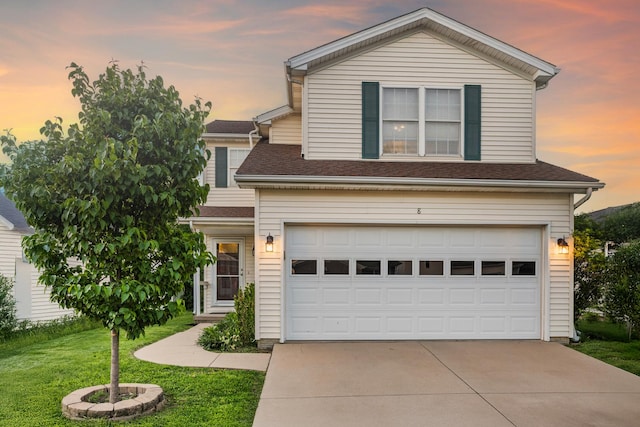 8 Harrison Ct, Bloomington, IL 61704 - traditional-style house with an attached garage, driveway, a yard, and a shingled roof