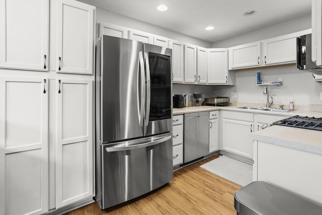 8 Harrison Ct, Bloomington, IL 61704 - kitchen featuring stainless steel appliances, a sink, light countertops, white cabinets, and recessed lighting